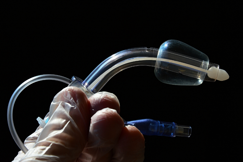 photo of medical worker holding tracheostomy tube