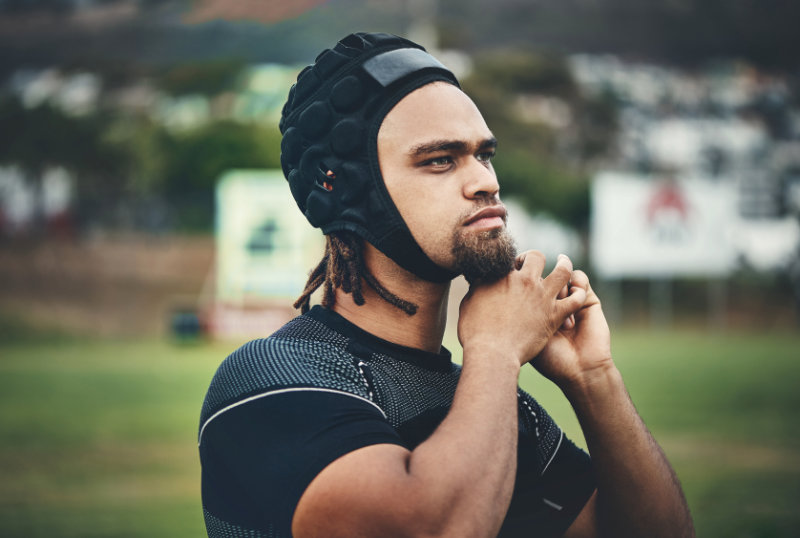 photo of man putting on soft sided headgear